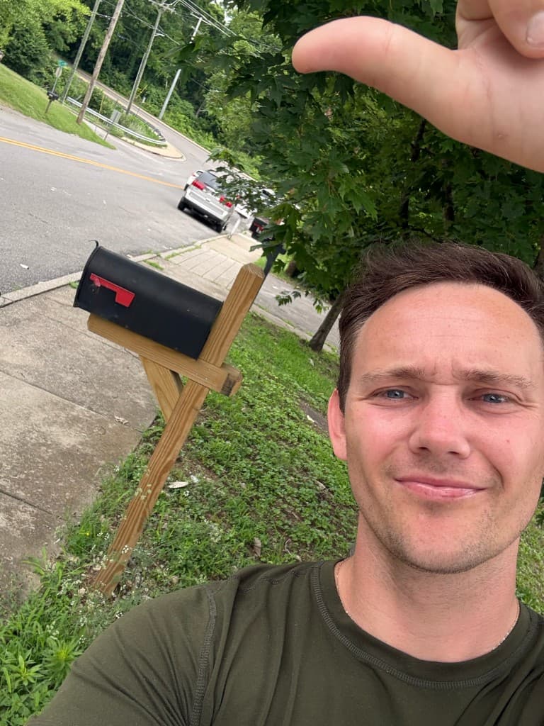 Mailbox Bros team member at a finished black post-mount mailbox install in Chico